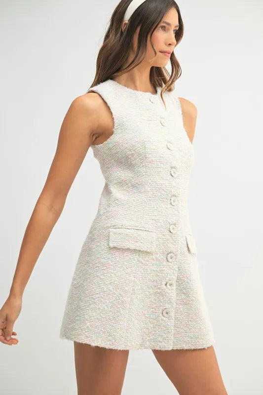 Side view of structured tweed mini dress with button front and subtle texture