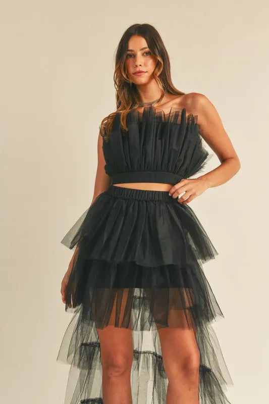 Full front view of black tulle ruffle outfit featuring strapless cropped bodice and voluminous skirt

