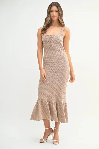 Neutral crochet midi dress styled for spring and summer, featuring soft body-hugging fit

