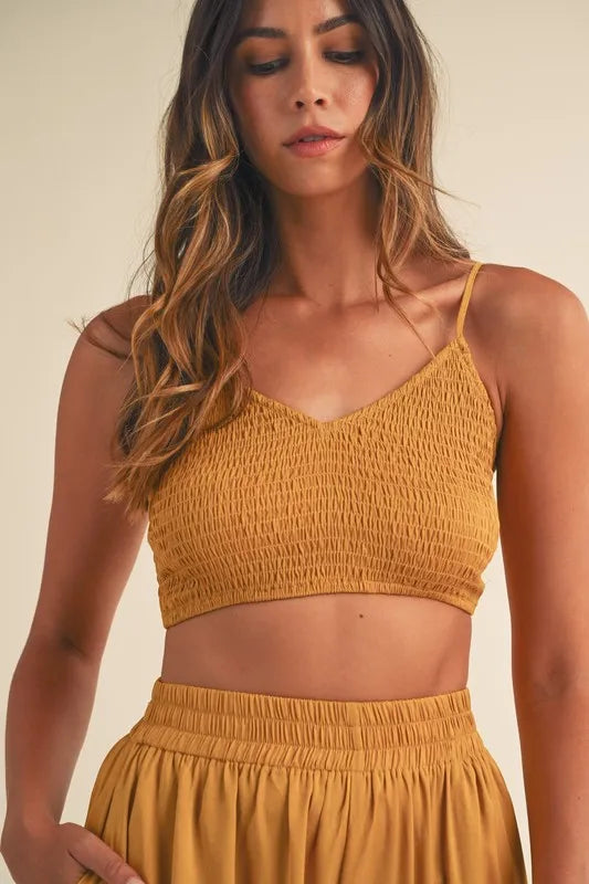 Upper body detail of smocked crop top with ruched fabric and flattering neckline

