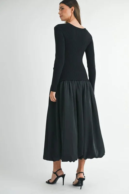 Back view of mixed fabric midi dress with ribbed knit bodice and soft gathered skirt