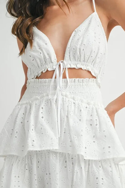 Close-up of cutout front detail and scalloped lace trim on mini dress bodice