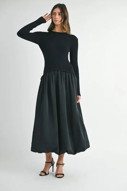 Black ribbed and poplin mixed media dress shown with model posing with arm raised