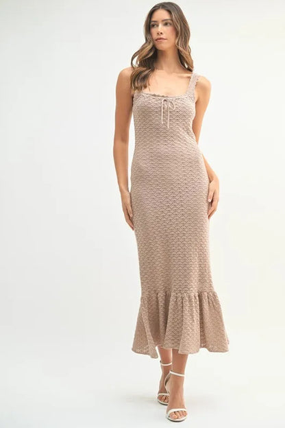 Neutral crochet midi dress styled for spring and summer, featuring soft body-hugging fit

