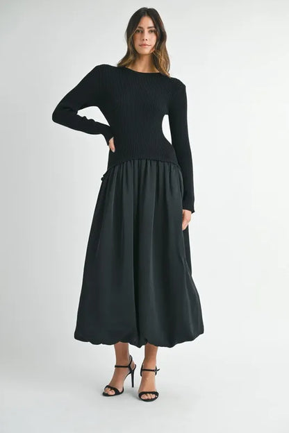 Black ribbed and poplin mixed media dress shown with model posing with arm raised